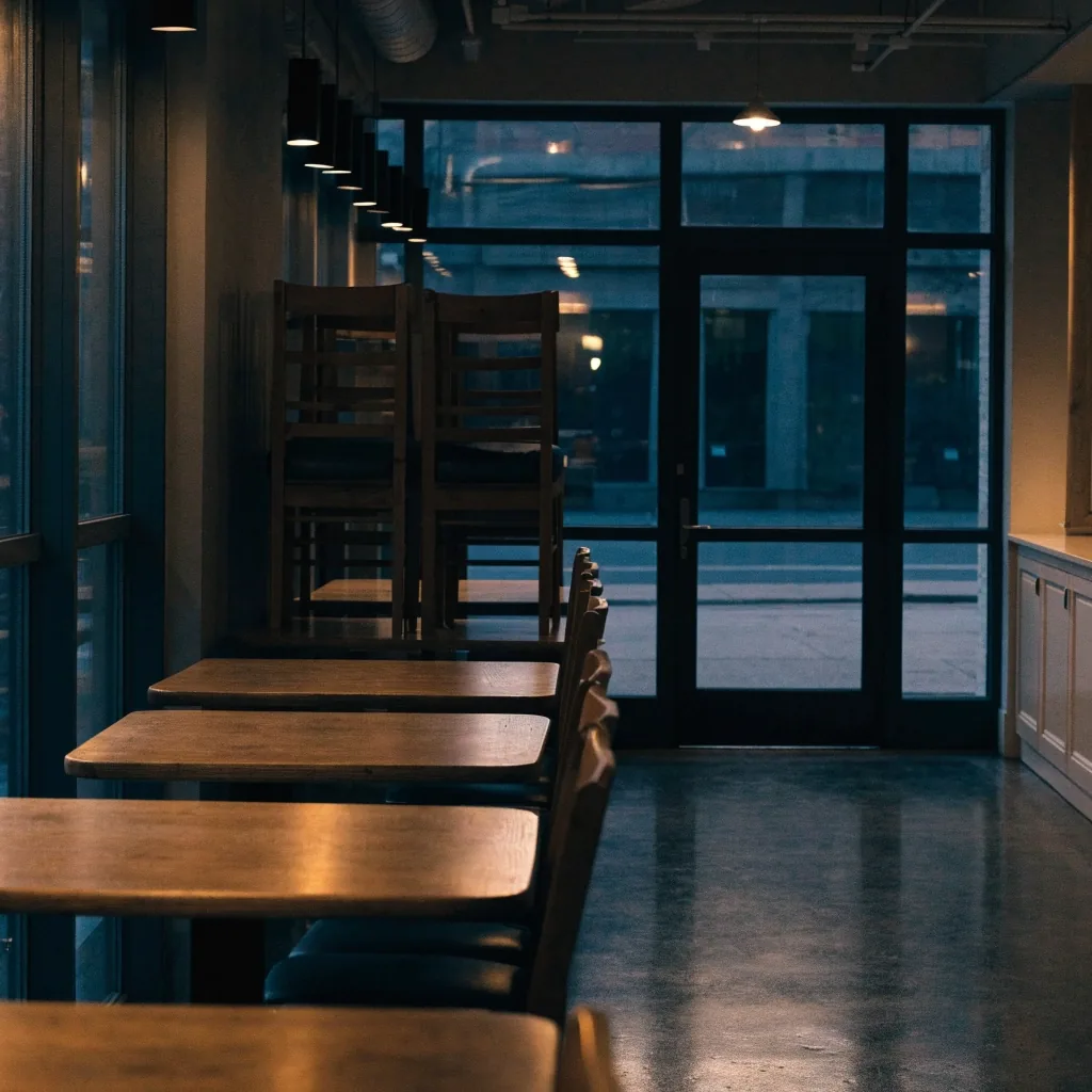 Quiet dining room at closing time with warm window light